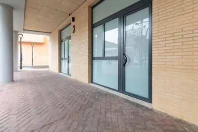 an empty hallway of a building with glass doors at Apartamento 2º nuevo 400 mt al mar in Valencia