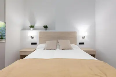 a bedroom with a large white bed with two pillows at Apartamento 2º nuevo 400 mt al mar in Valencia
