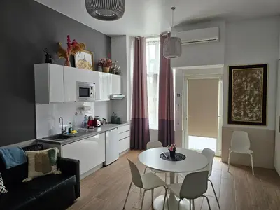 a living room with a table and a kitchen at Las Artes Luxury Double Room in Valencia