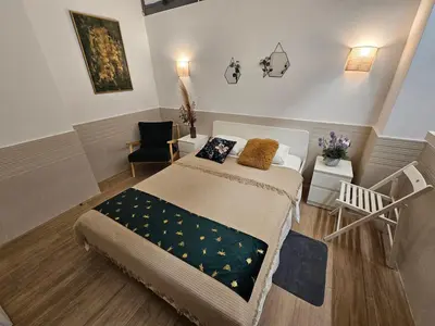 a small bedroom with a bed and a chair at Las Artes Luxury Double Room in Valencia