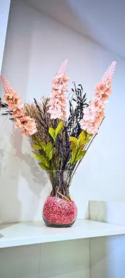 a vase filled with pink flowers on a shelf at Vacansis Loft Plaza del Pilar in Valencia