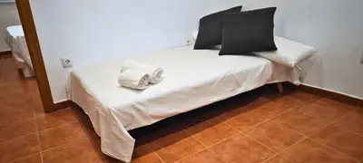 a bed with black and white sheets and pillows at Vacansis Loft Plaza del Pilar in Valencia