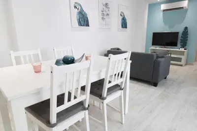 a living room with a white table and chairs at Vacansis Apartamento Malvarrosa in Valencia
