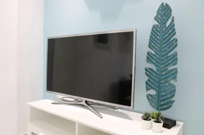 a flat screen tv sitting on top of a white shelf at Vacansis Apartamento Malvarrosa in Valencia