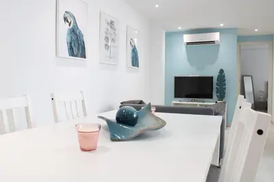 a room with a white table with a fish bowl on it at Vacansis Apartamento Malvarrosa in Valencia