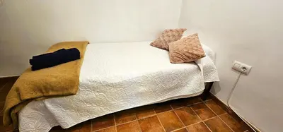 a small bed with two pillows on top of it at Vacansis Plaza de la Reina in Valencia