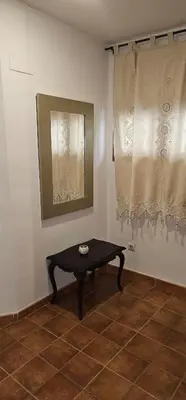 a table in the corner of a room with curtains at Vacansis Plaza de la Reina in Valencia