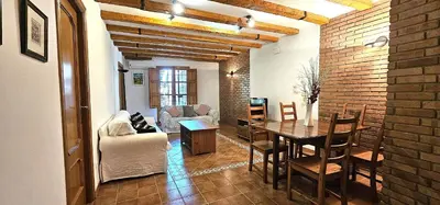 a living room with a table and a dining room at Vacansis Plaza de la Reina in Valencia