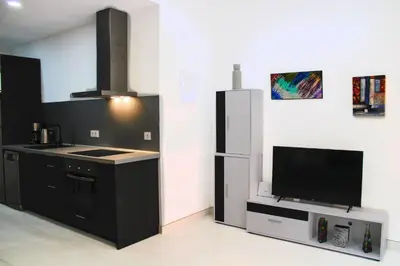 a kitchen with a refrigerator and a tv at Vacansis Bajo Loft Plus Ultra in Valencia