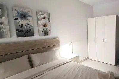 a bedroom with a bed and two paintings on the wall at Vacansis Bajo Loft Plus Ultra in Valencia