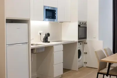 a kitchen with white cabinets and a washer and dryer at Luxury Apartment Oceanografic 6 pax in Valencia