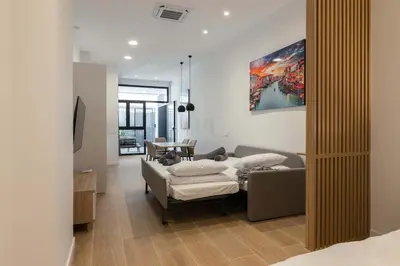 a living room with a couch and a table at Luxury Apartment Oceanografic 6 pax in Valencia