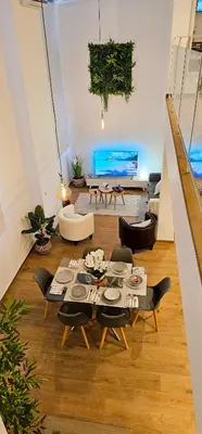 a bedroom with a bed and a tv on the wall at Dúplex-Lofts Les Arts i Les Ciències in Valencia