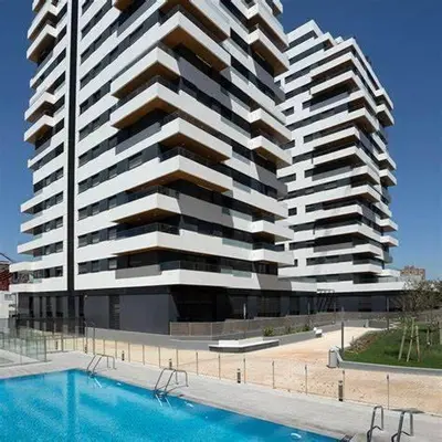 a swimming pool with blue water in a building at Dúplex-Lofts Les Arts i Les Ciències in Valencia
