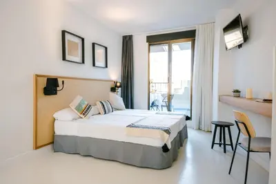 a hotel room with a bed and a balcony at BLUESEA Faro Cullera in Cullera