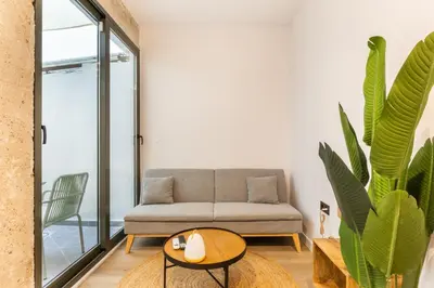 a living room with a couch and a table at Turía Flats by Nomad Host in Valencia