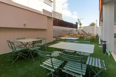 a group of tables and chairs on the side of a building at NIDO Malvarrosa Hotel - Apartamento in Valencia