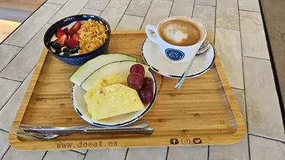 a tray with a plate of food and a cup of coffee at NIDO Malvarrosa Hotel - Apartamento in Valencia