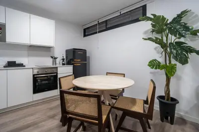 a kitchen with a table and chairs and a potted plant at VLC Host - Tamarit in Valencia