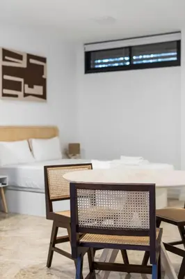 a dining room with a table and chairs and a bed at VLC Host - Tamarit in Valencia
