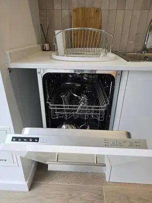 a dishwasher with its door open in a kitchen at Cozy Retreat in Heart of Valencia Perfect for Couples n Families in Valencia