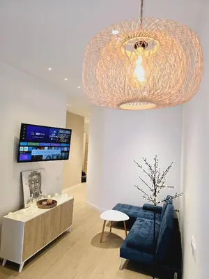 a living room with a blue couch and a chandelier at Cozy Retreat in Heart of Valencia Perfect for Couples n Families in Valencia