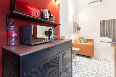 a microwave sitting on top of a table in a living room at The Little Village Apartments in Valencia