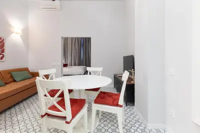 a living room with a white table and chairs at The Little Village Apartments in Valencia