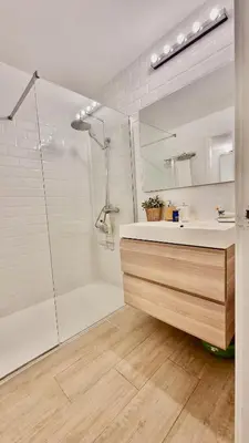 a bathroom with a shower and a sink and a mirror at Cozy Suite next to Plaza del Ayuntamiento in Valencia