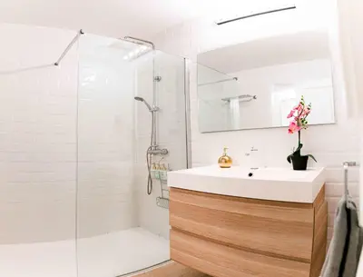 a white bathroom with a sink and a shower at Cozy Suite next to Plaza del Ayuntamiento in Valencia