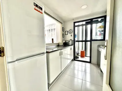 a white kitchen with a refrigerator and a window at Espacio-1, 2-H in Cullera