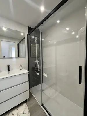 a bathroom with a glass shower and a sink at Espacio-1, 2-H in Cullera