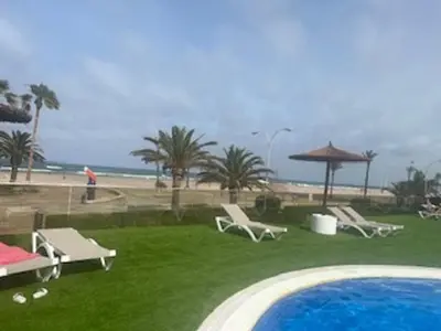 a resort with a swimming pool and a beach at Espacio-1, 2-H in Cullera