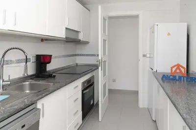 a white kitchen with a sink and a refrigerator at Espacio-1, 2-H in Cullera