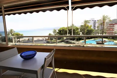 a table and chairs with a view of the ocean at Vacansis Apartamento Florazar 2, 4 in Cullera