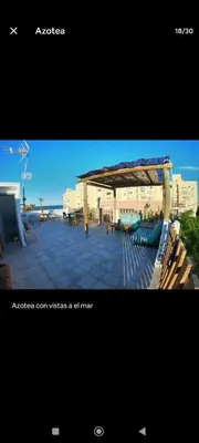 a picture of a patio with benches and a pavilion at Casa con piscina junto al mar in El Perellonet