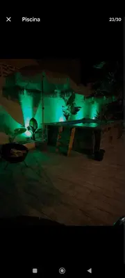 a night view of a building with green lights at Casa con piscina junto al mar in El Perellonet