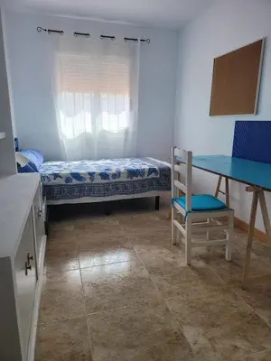 a kitchen with white cabinets and a refrigerator at Patriarch's Alfara Room in Alfara del Patriarca