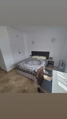 a bedroom with a bed and a desk with a desk at Room with private bathroom in Alfara del Patriarca