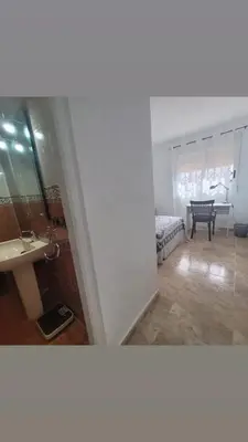a room with a table and chairs and a window at Room with private bathroom in Alfara del Patriarca