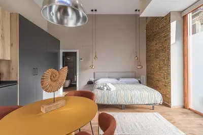 a bedroom with a bed and a table and chairs at Suite Premium junto al Río Turia 1 in Valencia