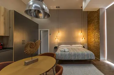 a bedroom with a bed and a table and chairs at Suite Premium junto al Río Turia 1 in Valencia