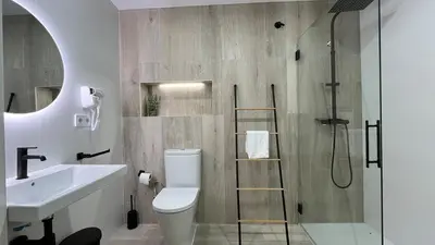 a bathroom with a shower and a toilet and a sink at Salabert Suite in Valencia