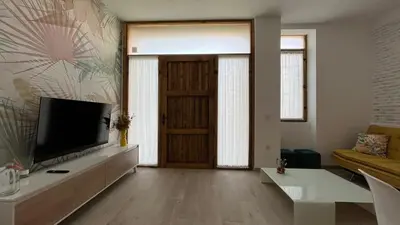 a living room with a television and a door at Salabert Suite in Valencia