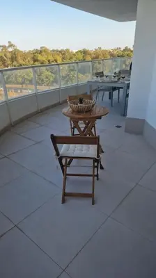 a balcony with tables and benches on a building at Appartement avec vue piscine in Canet de Berenguer