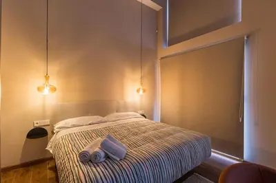 a bedroom with a bed with two towels on it at Premium Suite by the Turia River 3 in Valencia