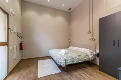 a small bedroom with a bed and a rug at Premium Suite by the Turia River 4 in Valencia