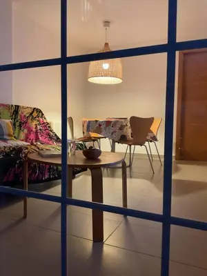 a living room with a table and a couch and chairs at La Calita del Versalles in Faro de Cullera