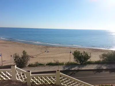 a view of the beach from a balcony at La Calita del Versalles in Faro de Cullera