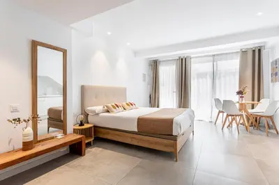 a bedroom with a bed and a mirror and a table at BiS Suites Ruzafa in Valencia